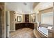 Luxurious bathroom with dual vanities, a soaking tub, and tile flooring at 9825 Ardrey Woods Dr, Charlotte, NC 28277
