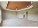 Bright bonus room with neutral paint, a tray ceiling, and views of the yard at 9825 Ardrey Woods Dr, Charlotte, NC 28277