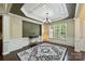 Formal dining room with wainscoting, modern lighting, and neutral color palette at 9825 Ardrey Woods Dr, Charlotte, NC 28277
