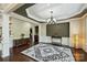 Formal dining room with wainscoting, modern lighting, and neutral color palette at 9825 Ardrey Woods Dr, Charlotte, NC 28277