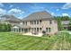 Back exterior view of home featuring a patio, outdoor furniture, grill, and green lawn at 9825 Ardrey Woods Dr, Charlotte, NC 28277