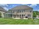 Exterior view of home with a patio, outdoor furniture, grill, and a lush green lawn at 9825 Ardrey Woods Dr, Charlotte, NC 28277