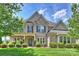 Attractive two-story brick home with lush front lawn and landscaping at 9825 Ardrey Woods Dr, Charlotte, NC 28277