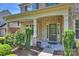Charming front porch with brick columns, plants, and welcoming entrance at 9825 Ardrey Woods Dr, Charlotte, NC 28277