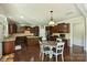 Gourmet kitchen with custom cabinets, granite counters, and a center island with seating at 9825 Ardrey Woods Dr, Charlotte, NC 28277
