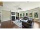 Spacious living room featuring hardwood floors, fireplace, and backyard view at 9825 Ardrey Woods Dr, Charlotte, NC 28277