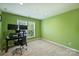 Green office space with neutral carpet, a modern desk, and lots of natural light at 9825 Ardrey Woods Dr, Charlotte, NC 28277
