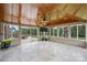 Bright sunroom with tile flooring, wood ceiling, and sliding doors to the backyard at 9825 Ardrey Woods Dr, Charlotte, NC 28277