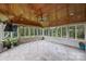Screened-in porch with tile flooring, wood paneled ceiling, and backyard views at 9825 Ardrey Woods Dr, Charlotte, NC 28277