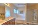 Bathroom featuring double sinks, a soaking tub, and a separate glass-enclosed shower at 105 Way Cross Ln, Troutman, NC 28166