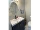 Updated bathroom with a modern vanity and stylish fixtures and oval mirror at 106 E Gibbs St, Dallas, NC 28034