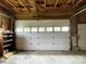 Attached garage with ample storage and a functional garage door at 106 E Gibbs St, Dallas, NC 28034