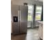 Spacious kitchen with stainless steel refrigerator, and windows with decorative curtains for a bright, open feel at 106 E Gibbs St, Dallas, NC 28034