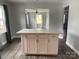Modern kitchen island with white cabinets, drawers, and quartz countertops with hardwood flooring at 106 E Gibbs St, Dallas, NC 28034