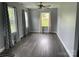 Bright living room with hardwood floors, ceiling fan, and windows with decorative curtains for an inviting atmosphere at 106 E Gibbs St, Dallas, NC 28034