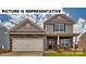 Charming two-story home featuring a stone facade, covered porch, and attached two-car garage at 111 Way Cross Ln, Troutman, NC 28166