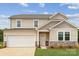 Charming two-story home featuring stone accents, a two-car garage, and a well-maintained lawn at 1117 Hallman Branch Ln, Lincolnton, NC 28092