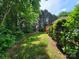 Lush backyard featuring green grass, mature trees, and well-maintained landscaping offering privacy at 1132 Preakness Nw Ct # 24, Concord, NC 28027