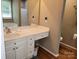 Bathroom vanity with a white countertop, undermount sink, and white cabinets with view of toilet and shower at 1132 Preakness Nw Ct # 24, Concord, NC 28027