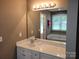 Bright bathroom vanity with large mirror and view of separate tub at 1132 Preakness Nw Ct # 24, Concord, NC 28027