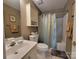 A cozy bathroom featuring a tub with shower curtain, toilet, and white vanity with a cabinet above at 1132 Preakness Nw Ct # 24, Concord, NC 28027