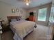 Bedroom with neutral carpet, queen size bed, dresser with TV, and window with natural light at 1132 Preakness Nw Ct # 24, Concord, NC 28027