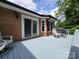 Back deck with light blue floor, red brick, and seating area for relaxation or entertaining at 1132 Preakness Nw Ct # 24, Concord, NC 28027
