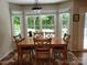 Bright dining room with large windows, a wooden table, chairs, and a view of the outdoors at 1132 Preakness Nw Ct # 24, Concord, NC 28027
