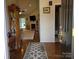 Inviting entryway with hardwood floors, decorative rug, and a view into the cozy living room at 1132 Preakness Nw Ct # 24, Concord, NC 28027