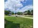 Spacious front yard with lush green grass, mature trees, and a view of the quiet neighborhood street at 1132 Preakness Nw Ct # 24, Concord, NC 28027