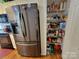 View of the kitchen featuring a stainless steel refrigerator and walk-in pantry with stocked shelving at 1132 Preakness Nw Ct # 24, Concord, NC 28027