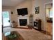 Comfortable living room featuring a fireplace, large windows, and access to the outdoor patio at 1132 Preakness Nw Ct # 24, Concord, NC 28027