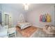 A charming bedroom features a decorative canopy bed and soft pink accents at 123 Archbell Point Ln, Mooresville, NC 28117