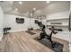 Bright exercise room includes a mirror wall, mounted television, and open shelving for equipment at 123 Archbell Point Ln, Mooresville, NC 28117