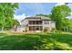 Exterior shot of the home showing a stone firepit, patio, and a screened-in porch at 123 Archbell Point Ln, Mooresville, NC 28117