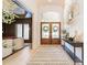 Elegant foyer featuring hardwood floors, stylish console table, and decorative mirror at 123 Archbell Point Ln, Mooresville, NC 28117