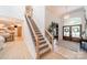 Inviting foyer with staircase featuring wooden treads, black metal balusters, and hardwood floors at 123 Archbell Point Ln, Mooresville, NC 28117