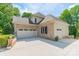 Side view of a brick house with a spacious three-car garage and ample driveway space at 123 Archbell Point Ln, Mooresville, NC 28117