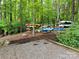 Secluded kayak storage area nestled among trees, providing organized storage for recreational watercraft at 123 Archbell Point Ln, Mooresville, NC 28117