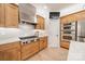 Modern kitchen with stainless steel range hood, gas cooktop, and custom wood cabinets at 123 Archbell Point Ln, Mooresville, NC 28117