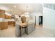 Spacious open concept kitchen with a marble island, wood cabinets, dining area, and staircase at 123 Archbell Point Ln, Mooresville, NC 28117
