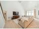 Bright living room with a vaulted ceiling, large sectional sofa, and a modern entertainment center at 123 Archbell Point Ln, Mooresville, NC 28117