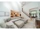 Spacious living room featuring a large sectional sofa, open layout, and stairs to the second floor at 123 Archbell Point Ln, Mooresville, NC 28117