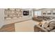 Inviting living room features built-in shelving, TV, and stylish leather sofa at 123 Archbell Point Ln, Mooresville, NC 28117