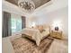 Comfortable main bedroom with chandelier, cozy rug, and natural light from a large window at 123 Archbell Point Ln, Mooresville, NC 28117