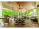 Covered back porch features a grill, outdoor seating, ceiling fans, and wooded backyard views at 123 Archbell Point Ln, Mooresville, NC 28117