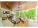 Relaxing back porch features a sofa, outdoor seating, a grill, and wooded backyard views at 123 Archbell Point Ln, Mooresville, NC 28117