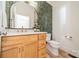 Stylish powder room with green tile wall, wood vanity, and modern fixtures at 123 Archbell Point Ln, Mooresville, NC 28117
