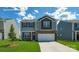 Charming two-story home featuring a two-car garage, landscaped lawn and neutral tones at 129 Way Cross Ln, Troutman, NC 28166