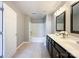 Bright bathroom with double vanity, sleek dark cabinets, shower-tub and tile floors at 1295 Amber Ridge Nw Rd, Concord, NC 28027